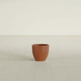 Wannsee Round Planter in Matte Terra Cotta, 15"D × 13"H, shown empty