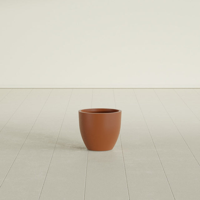 Wannsee Round Planter in Matte Terra Cotta, 15"D × 13"H, shown empty