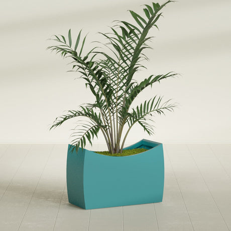 Seoul Curved fiberglass planter in Satin Seafoam Green, shown planted, in a sunlit interior