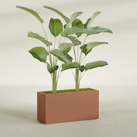 Tolga Corner fiberglass planter in Matte Terra Cotta, shown planted, in a sunlit interior