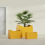 Seoul Curved fiberglass planter in Gloss Saffron, size range, in a sunlit interior