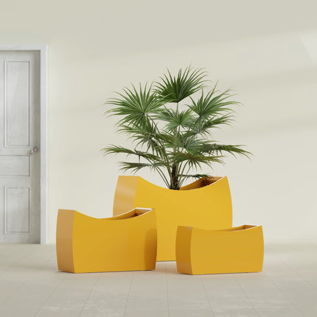 Seoul Curved fiberglass planter in Gloss Saffron, size range, in a sunlit interior