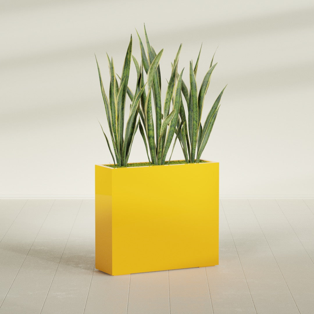 Delray Corner fiberglass planter in Gloss Saffron, shown planted, in a sunlit interior