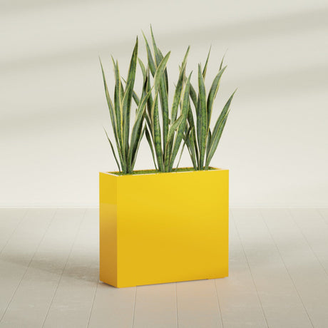 Delray Corner fiberglass planter in Gloss Saffron, shown planted, in a sunlit interior