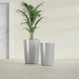 Tegel Round Tapered fiberglass planter in Metallic Silver, size range, in a sunlit interior