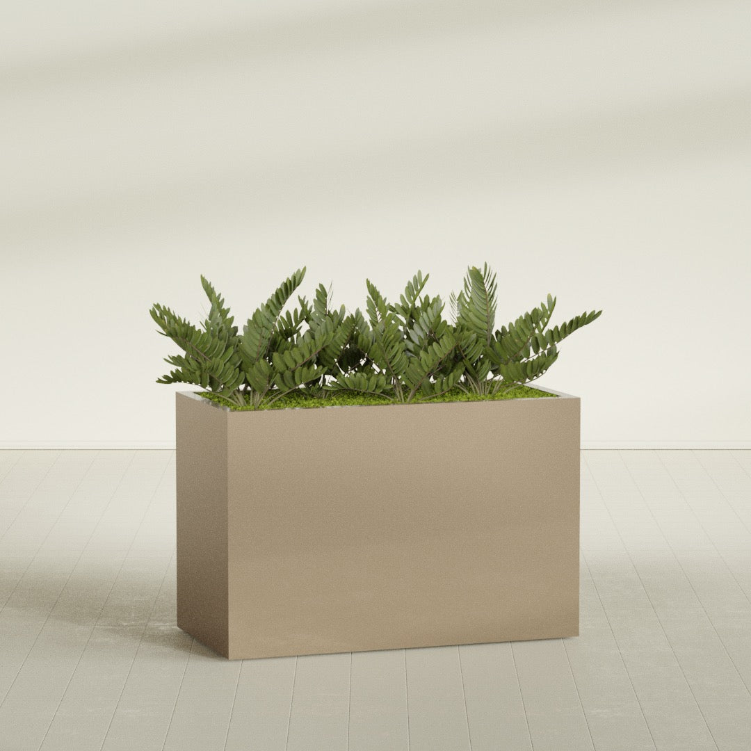 Brisbane Rectangular fiberglass planter in Gloss Metallic Gold, shown planted, in a sunlit interior