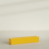 Salon Box Planter in Gloss Saffron, 42" Long, shown empty