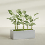 Torino Wide Rectangular fiberglass planter in Metallic Silver, shown planted, in a sunlit interior