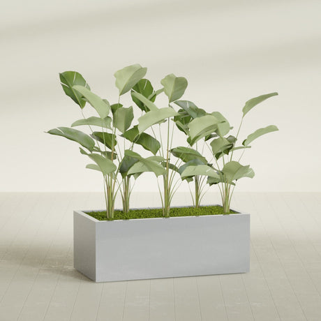Torino Wide Rectangular fiberglass planter in Metallic Silver, shown planted, in a sunlit interior