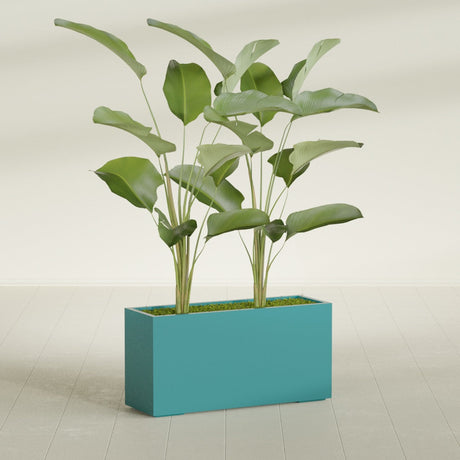 Tolga Rectangular fiberglass planter in Satin Seafoam Green, shown planted, in a sunlit interior