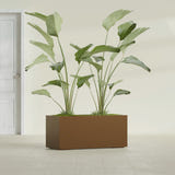 Badalona Rectangular fiberglass planter in Metallic Bronze, shown planted, in a sunlit interior