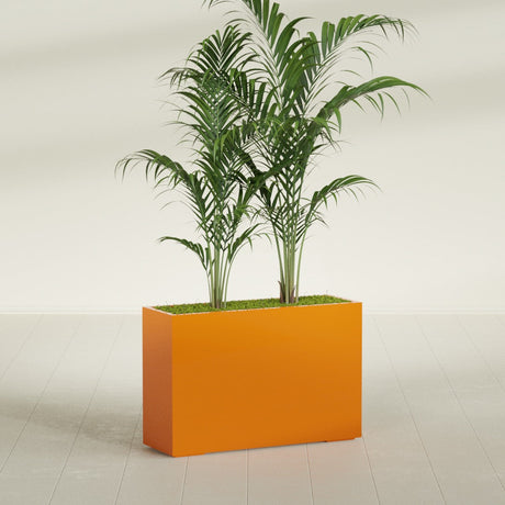 Potsdam Corner fiberglass planter in Gloss Tangerine, shown planted, in a sunlit interior