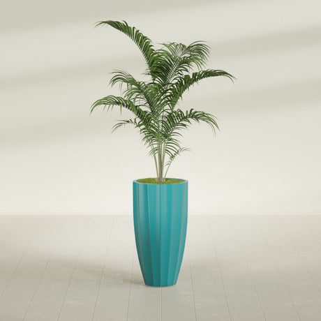 San Jose Tall Fluted fiberglass planter in Satin Seafoam Green, shown planted, in a sunlit interior