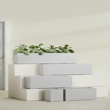 Cuba Corner fiberglass planter in Metallic Silver, size range, in a sunlit interior