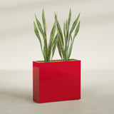 Perth Corner fiberglass planter in Gloss Red, shown planted, in a sunlit interior