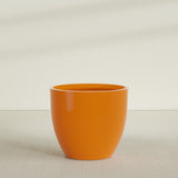 Wannsee Round Planter in Gloss Tangerine, 50"D × 44"H, shown empty