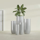 Saint Tropez Bullet Round fiberglass planter in Metallic Silver, size range, in a sunlit interior