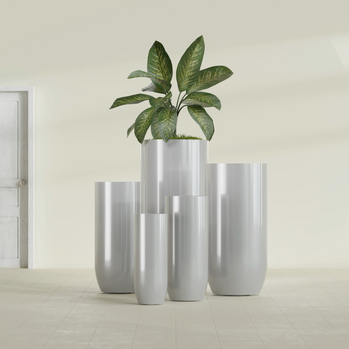 Saint Tropez Bullet Round fiberglass planter in Metallic Silver, size range, in a sunlit interior