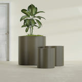 Rio Grande Cylinder fiberglass planter in Matte Bronze, size range, in a sunlit interior