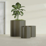 Rio Grande Cylinder fiberglass planter in Matte Bronze, size range, in a sunlit interior