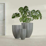 Alicante Fluted fiberglass planter in Matte Gunmetal, size range, in a sunlit interior