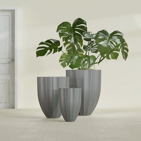 Alicante Fluted fiberglass planter in Matte Gunmetal, size range, in a sunlit interior