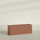 Miami Narrow Rectangular Planter in Matte Terra Cotta, 48"L × 12"D × 18"H, shown empty