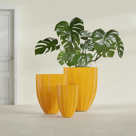 Alicante Fluted fiberglass planter in Gloss Saffron, size range, in a sunlit interior