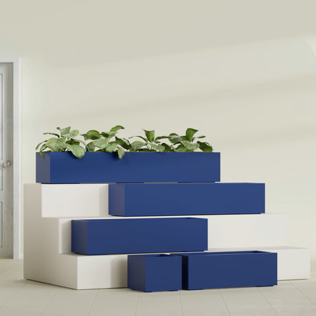Cuba Corner fiberglass planter in Matte Cobalt Blue, size range, in a sunlit interior