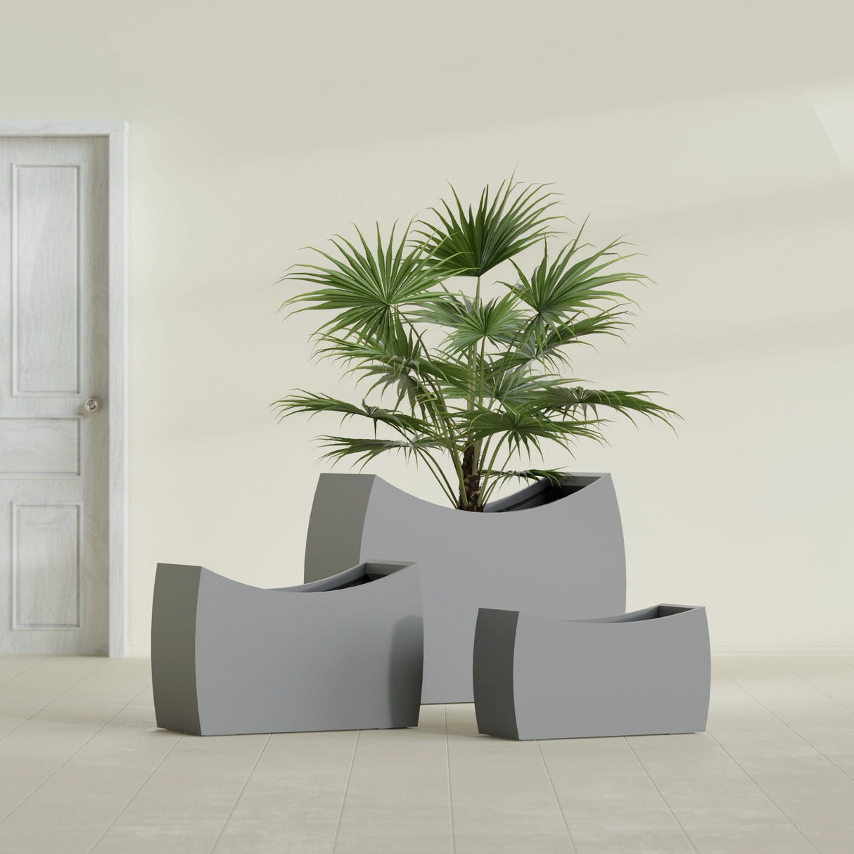 Seoul Curved fiberglass planter in Matte Gunmetal, size range, in a sunlit interior