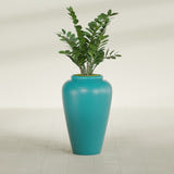 Barà Jar fiberglass planter in Satin Seafoam Green, shown planted, in a sunlit interior