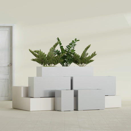 Tolga Corner fiberglass planter in Metallic Silver, size range, in a sunlit interior