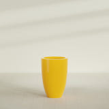 Brannan Tapered Round Planter in Gloss Saffron, 24"D × 35"H, shown empty