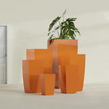 Toulan Tapered Square fiberglass planter in Gloss Tangerine, size range, in a sunlit interior