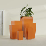 Toulan Tapered Square fiberglass planter in Gloss Tangerine, size range, in a sunlit interior