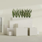 Granada fiberglass planter in Satin Beige, size range, in a sunlit interior