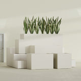 Granada fiberglass planter in Satin Beige, size range, in a sunlit interior