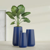 Saigon Tapered Round fiberglass planter in Matte Cobalt Blue, size range, in a sunlit interior