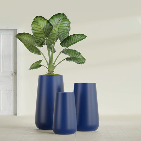 Saigon Tapered Round fiberglass planter in Matte Cobalt Blue, size range, in a sunlit interior