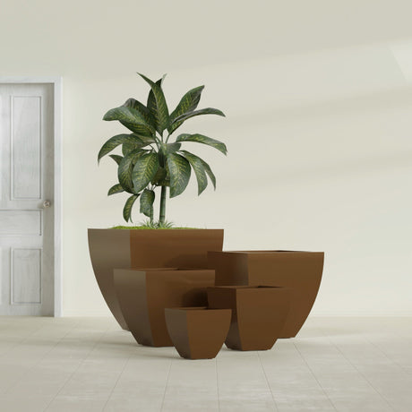 Lima Tapered Square fiberglass planter in Metallic Bronze, size range, in a sunlit interior