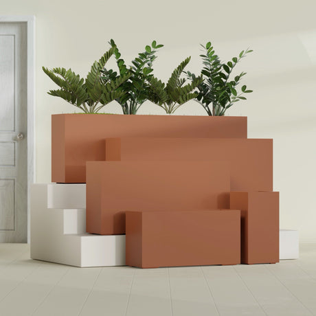 Hollywood Corner fiberglass planter in Matte Terra Cotta, size range, in a sunlit interior