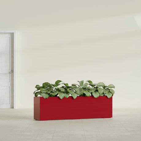 Hudson Extra Long fiberglass planter in Gloss Red, shown planted, in a sunlit interior