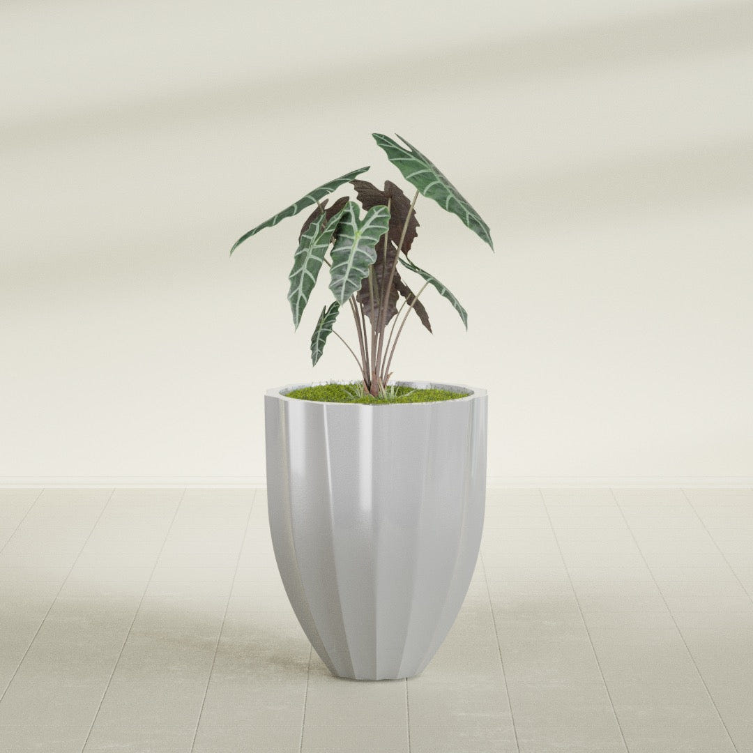 Alicante Fluted fiberglass planter in Metallic Silver, shown planted, in a sunlit interior