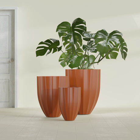 Alicante Fluted fiberglass planter in Matte Terra Cotta, size range, in a sunlit interior