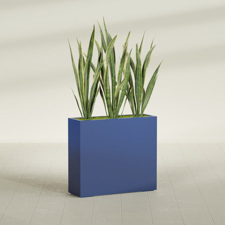 Delray Corner fiberglass planter in Matte Cobalt Blue, shown planted, in a sunlit interior