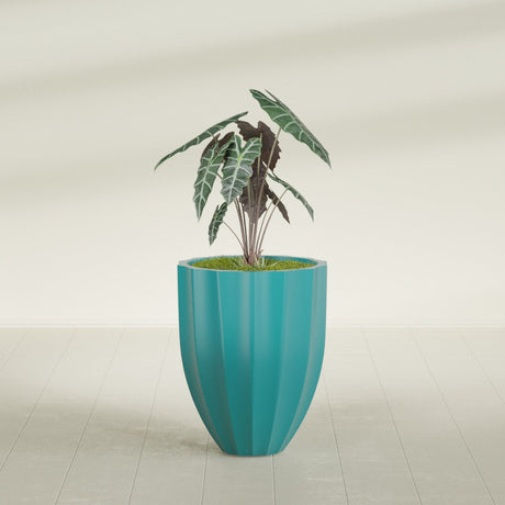 Alicante Fluted fiberglass planter in Satin Seafoam Green, shown planted, in a sunlit interior