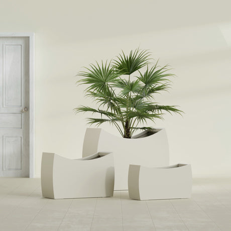 Seoul Curved fiberglass planter in Satin Beige, size range, in a sunlit interior