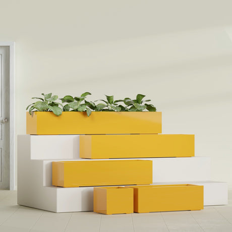 Cuba Corner fiberglass planter in Gloss Saffron, size range, in a sunlit interior