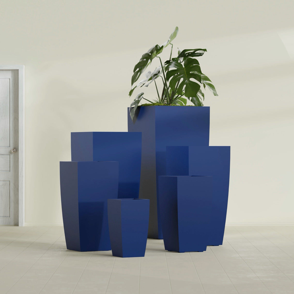Toulan Tapered Square fiberglass planter in Matte Cobalt Blue, size range, in a sunlit interior