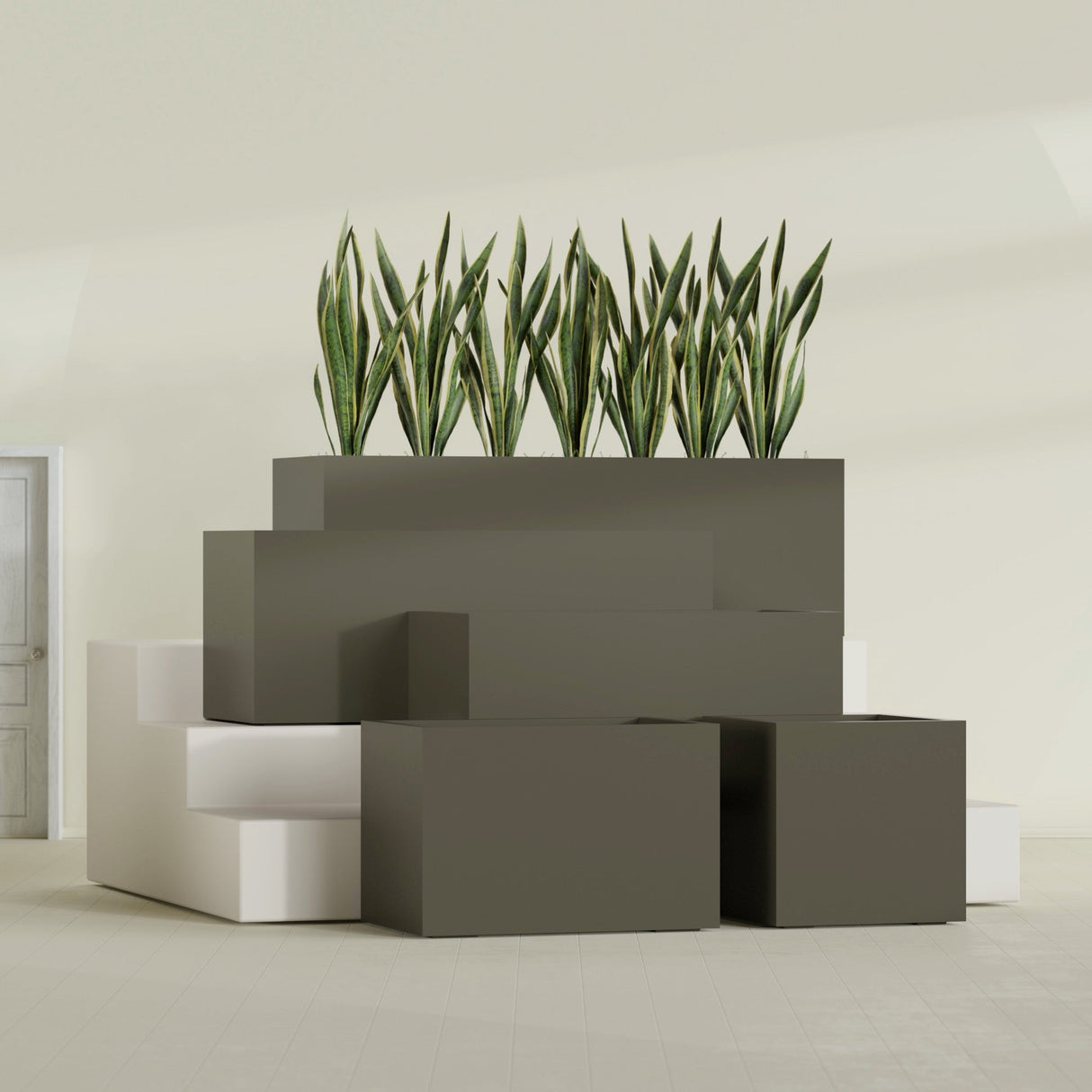 Granada fiberglass planter in Matte Bronze, size range, in a sunlit interior